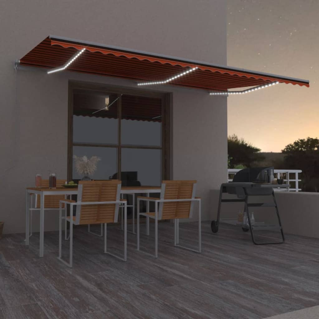 Ręcznie zwijana markiza z LED, 600x300 cm, pomarańczowo-brązowa vidaXL
